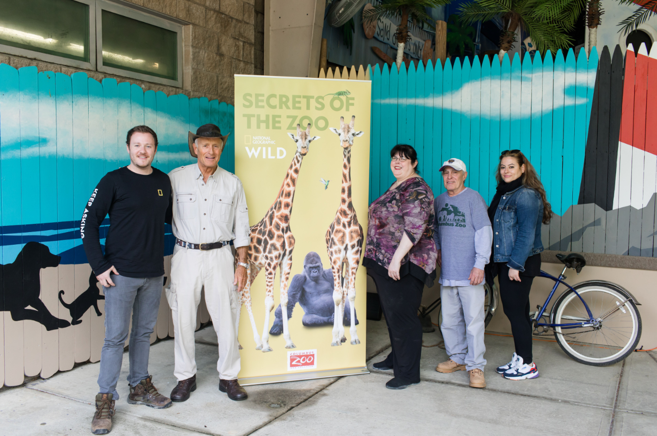 photo of Nat Geo reporters on the trip, pose with Jack Hanna and trainer, Joel Slaven.